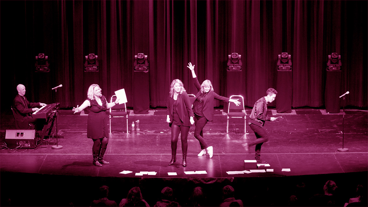 A pink filtered photograph of Girls Nite Out onstage